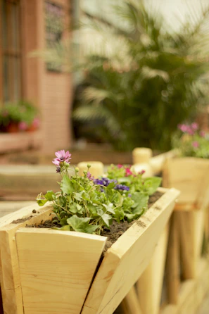 A stunning outdoor wood planter box filled with vibrant flowers.