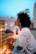 woman in white collared shirt looking at the city during night time