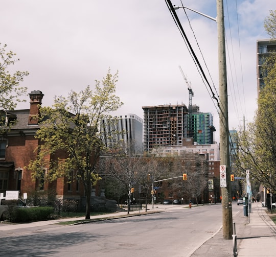 brown concrete building near green trees during daytime in Ottawa Canada