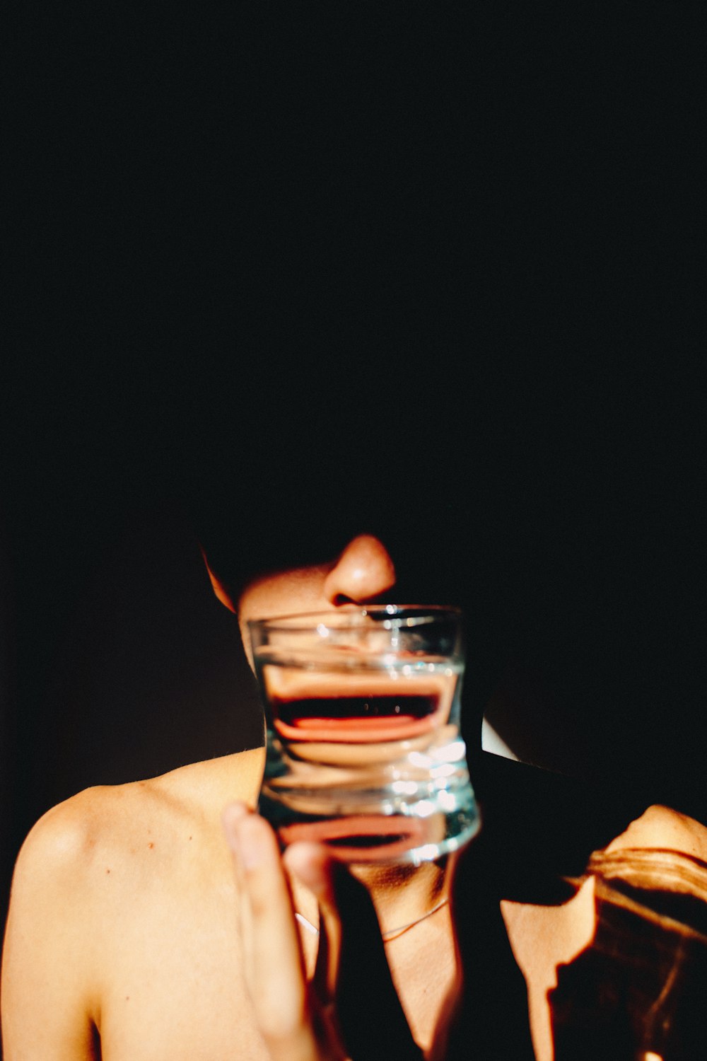 person holding clear drinking glass with water