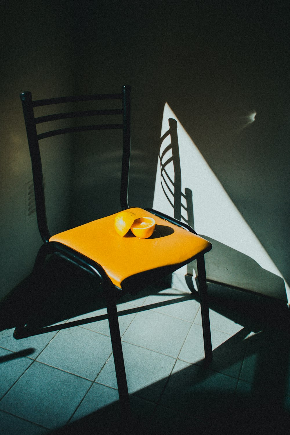 black metal framed yellow padded chair