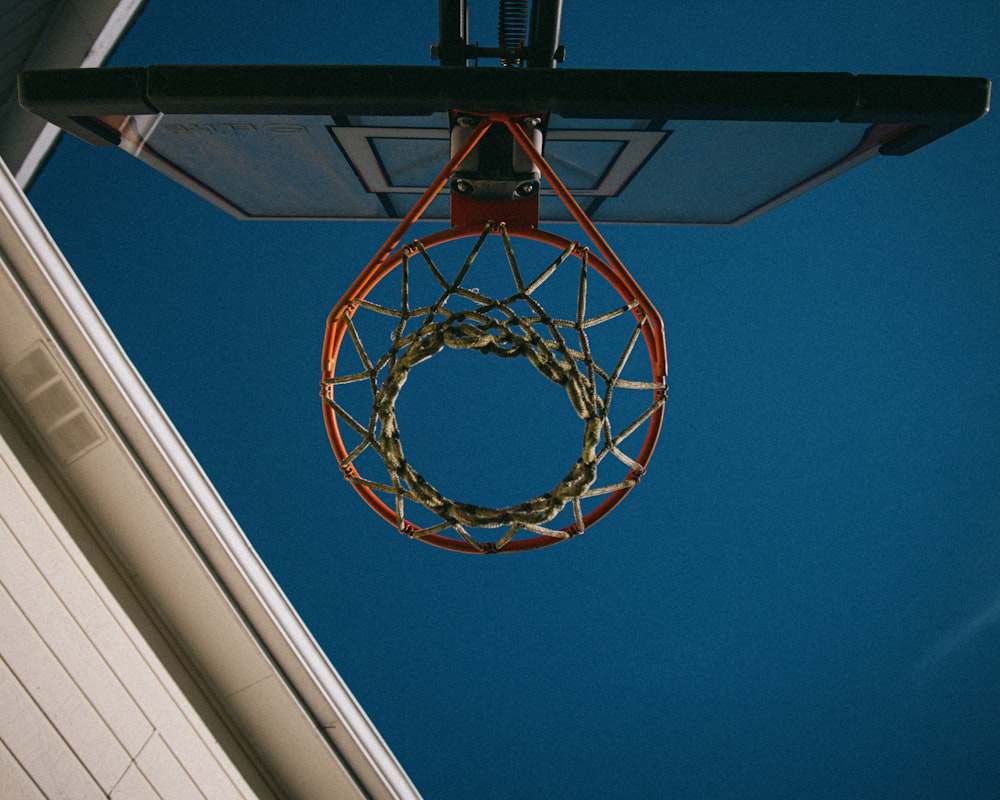 brown and white basketball hoop under blue sky during daytime