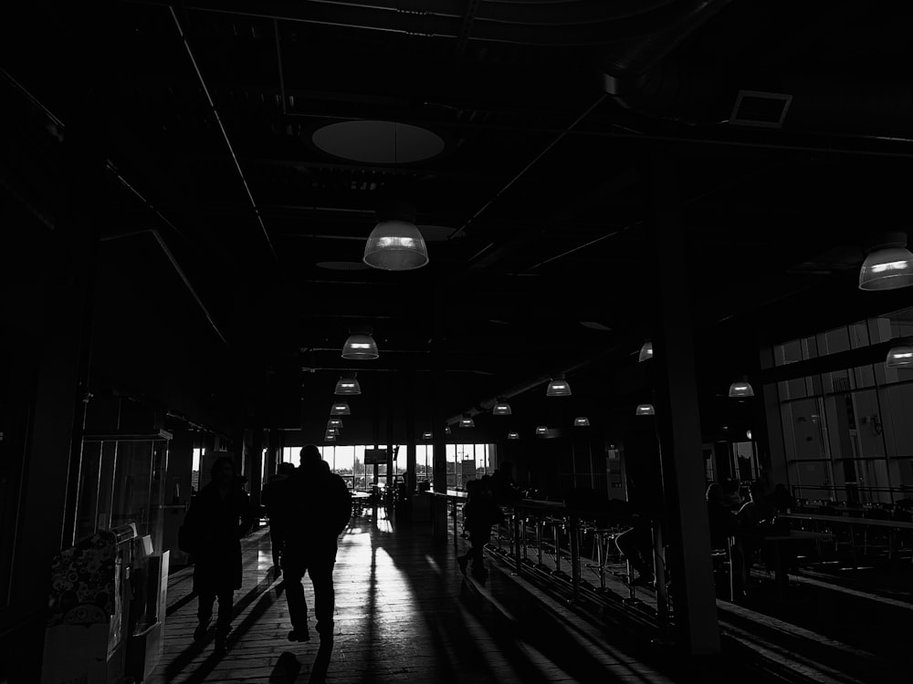 grayscale photo of people walking on street