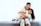 2 women sitting on gray couch