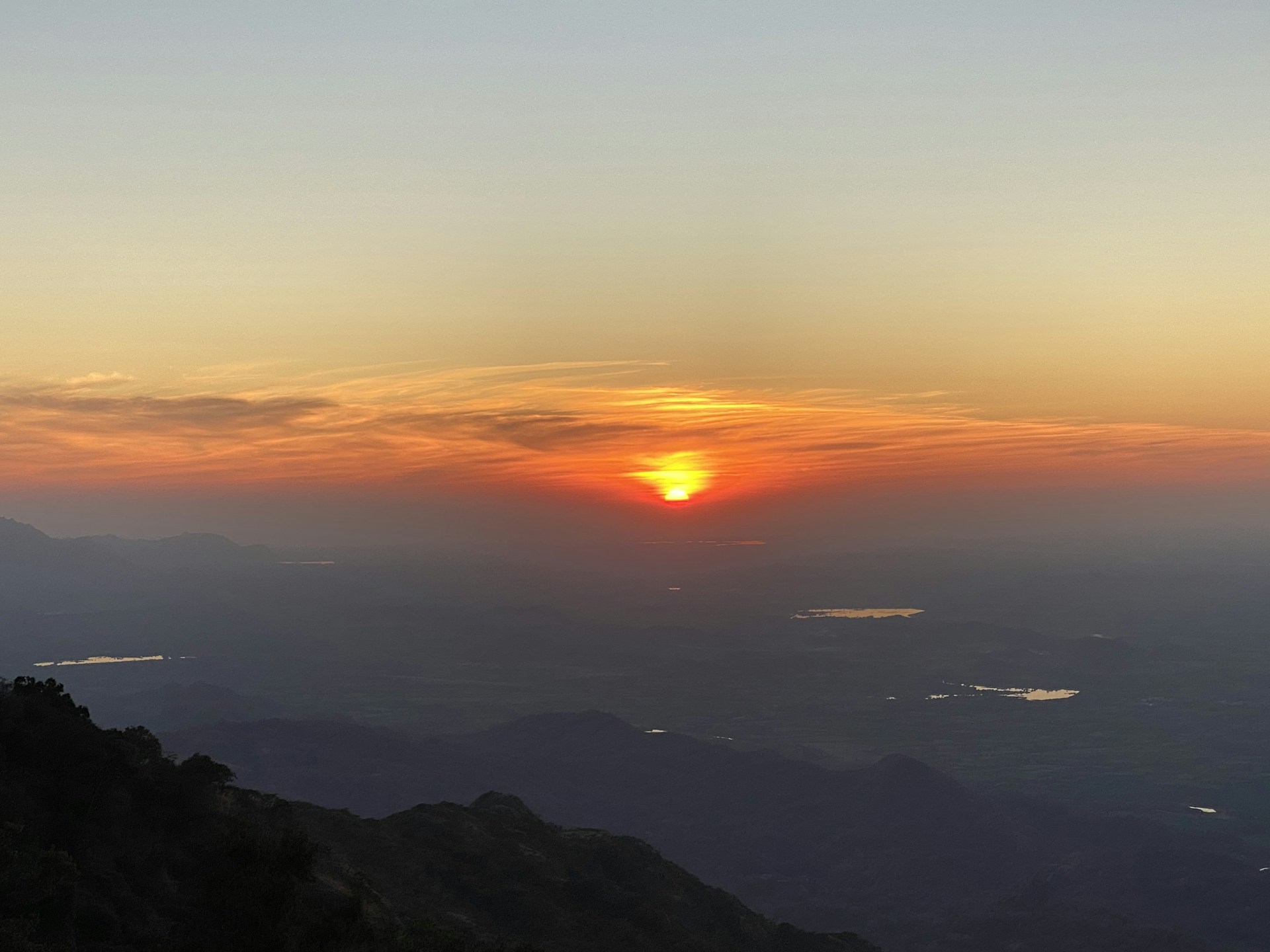 A breathtaking view of the red sky at dawn, with soft pink and orange hues blending into the morning light.