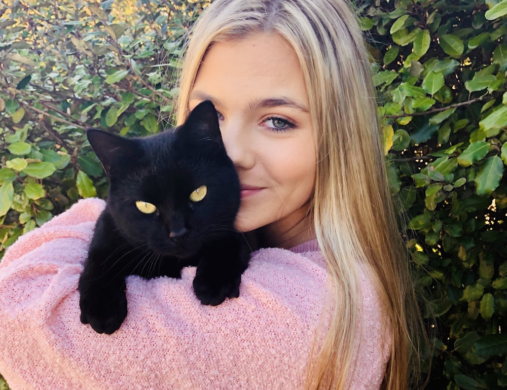 woman with black cat on her lap