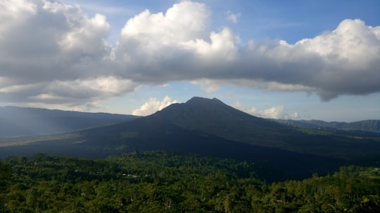 green mountain under white clouds during daytime in Tempat Wisata Penelokan Kintamani Indonesia