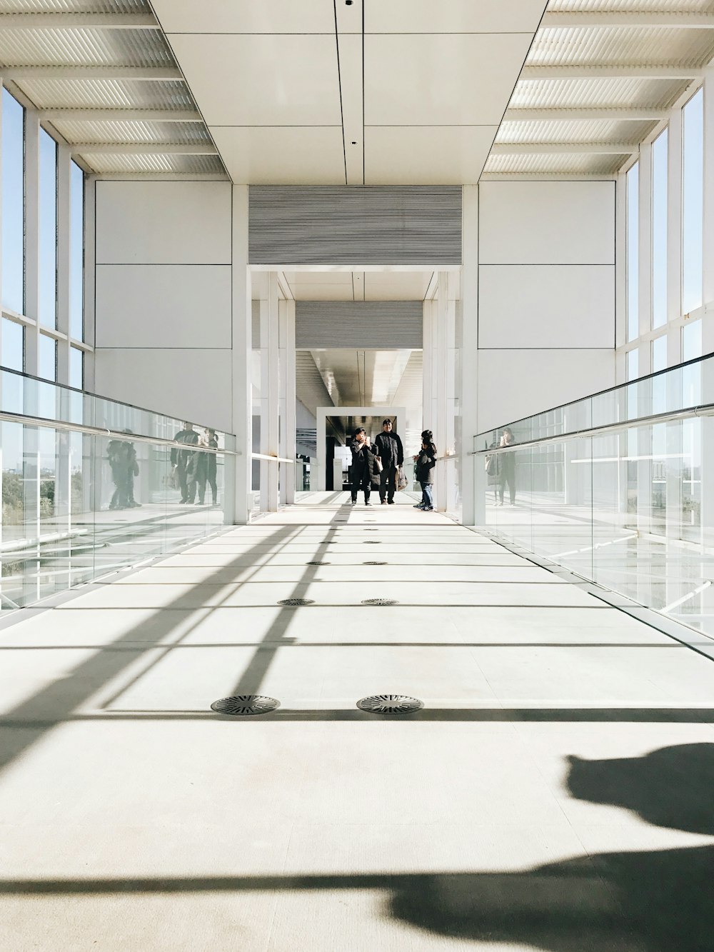 person in black jacket walking on hallway