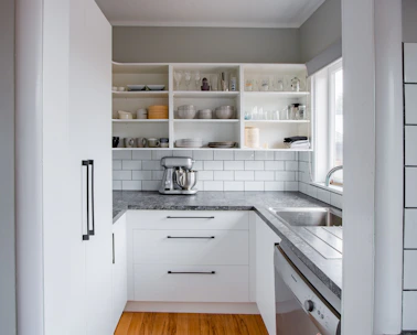 Display of modern kitchen appliances arranged neatly on shelves.