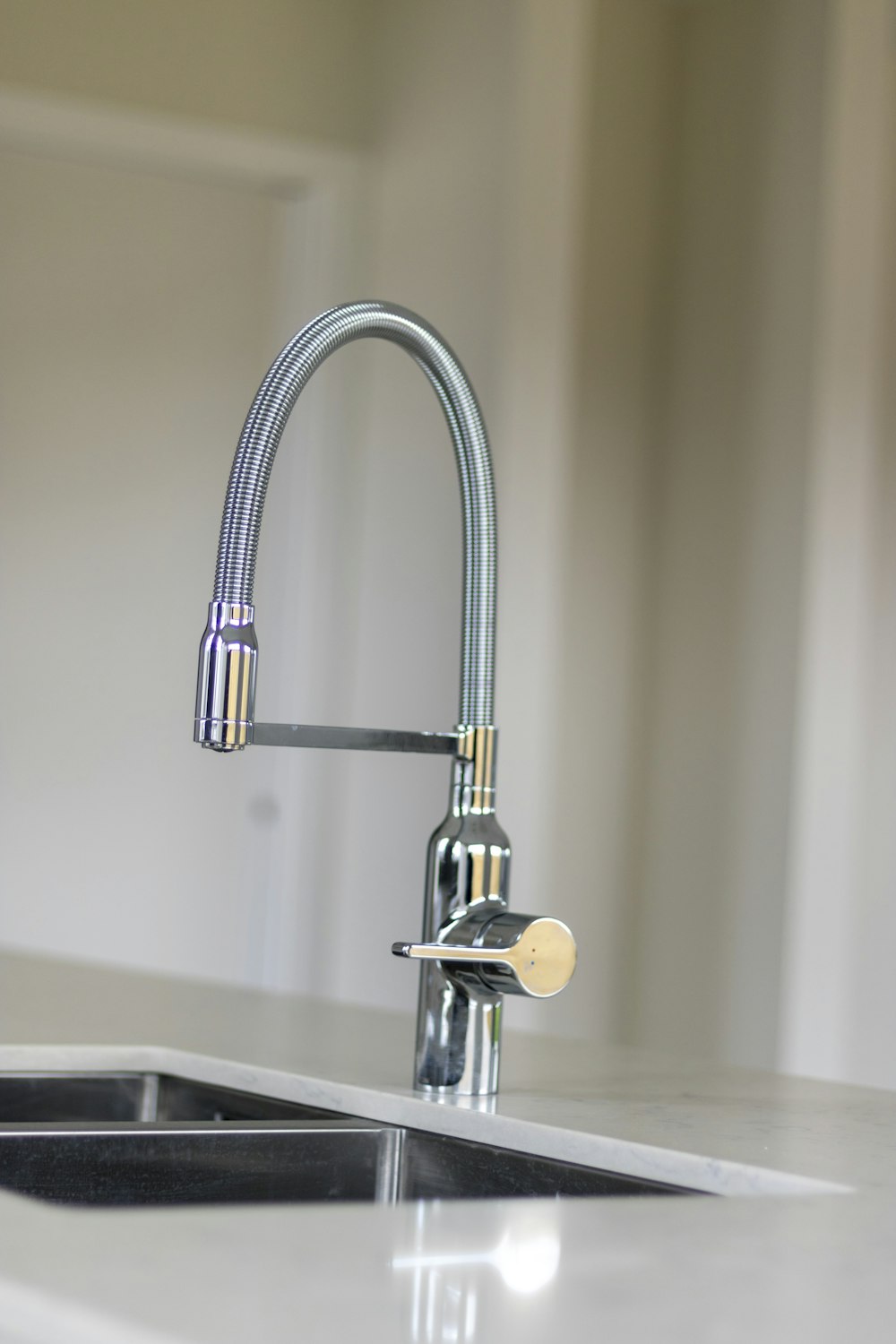 silver faucet on brown wooden table