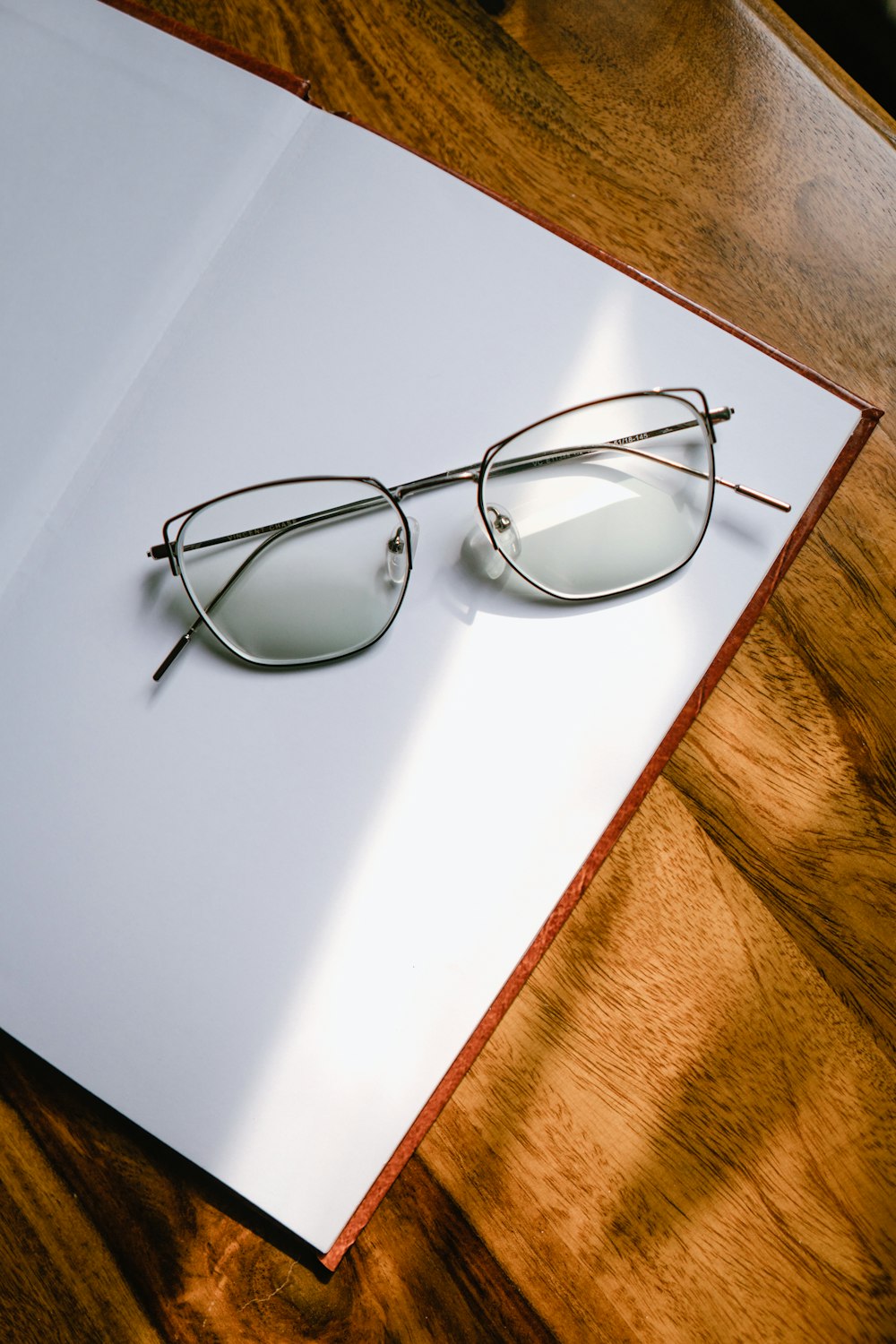 black framed eyeglasses on white table