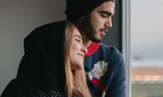 man in black hoodie and woman in red sweater
