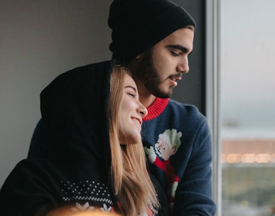 man in black hoodie and woman in red sweater