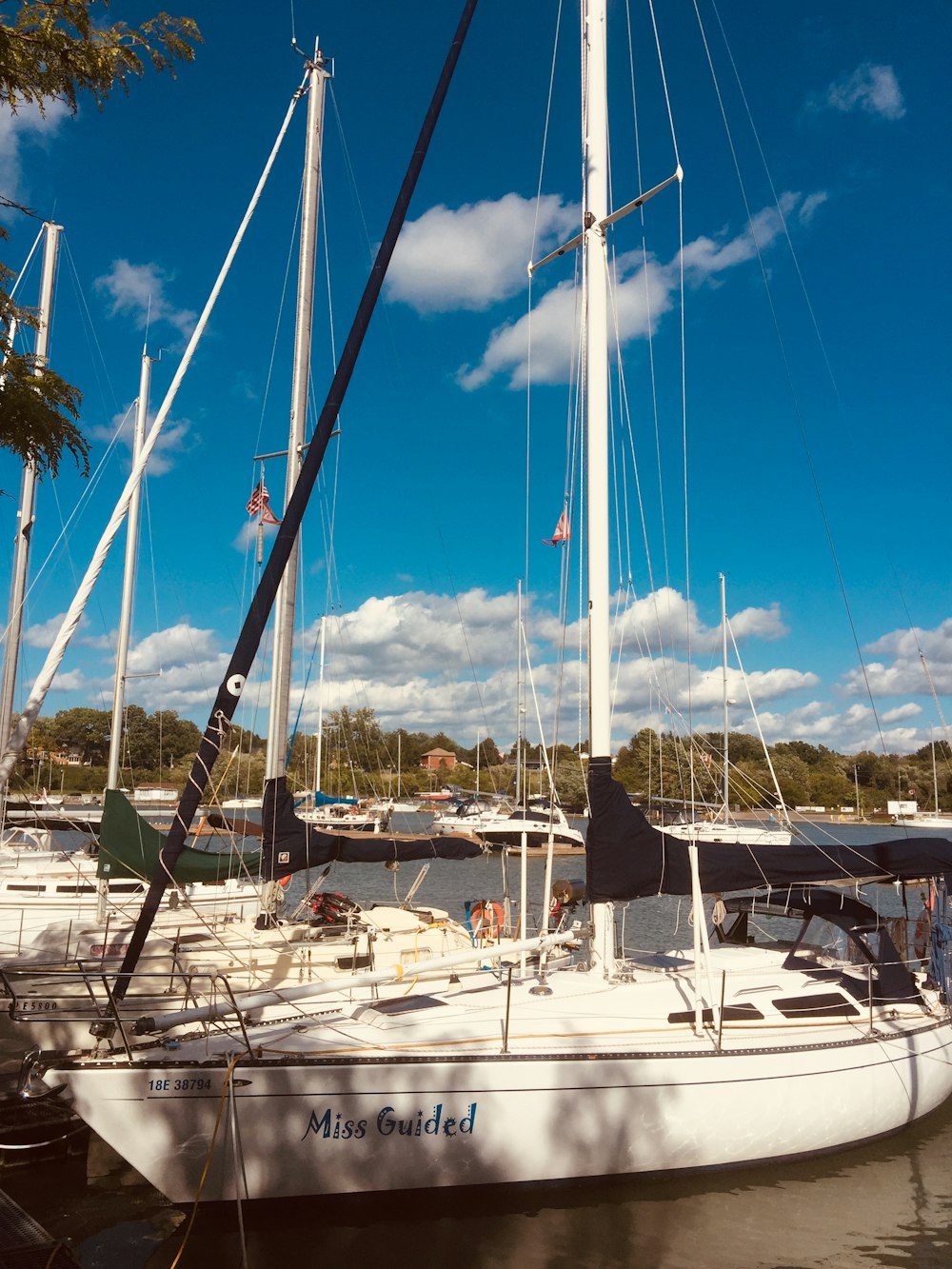 white sail boat on dock during daytime