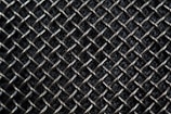 A close-up view of a metallic mesh pattern with interwoven wires forming a grid-like structure. The background appears dark, highlighting the reflective quality of the silver-colored metal.