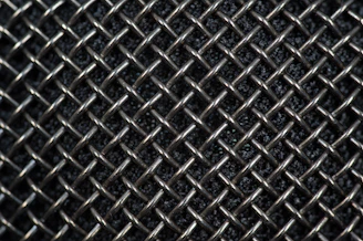 Close-up of stainless steel woven mesh used in industrial filtration equipment.