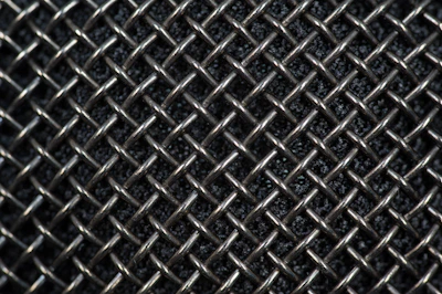 Close-up of stainless steel woven mesh used in industrial filtration equipment.
