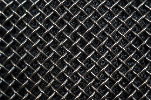 Close-up of stainless steel filter mesh tightly woven for industrial use.
