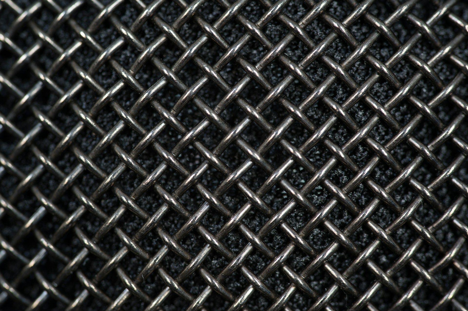 Close-up of durable wire mesh netting neatly rolled, showcasing its sturdy weave and metallic shine.