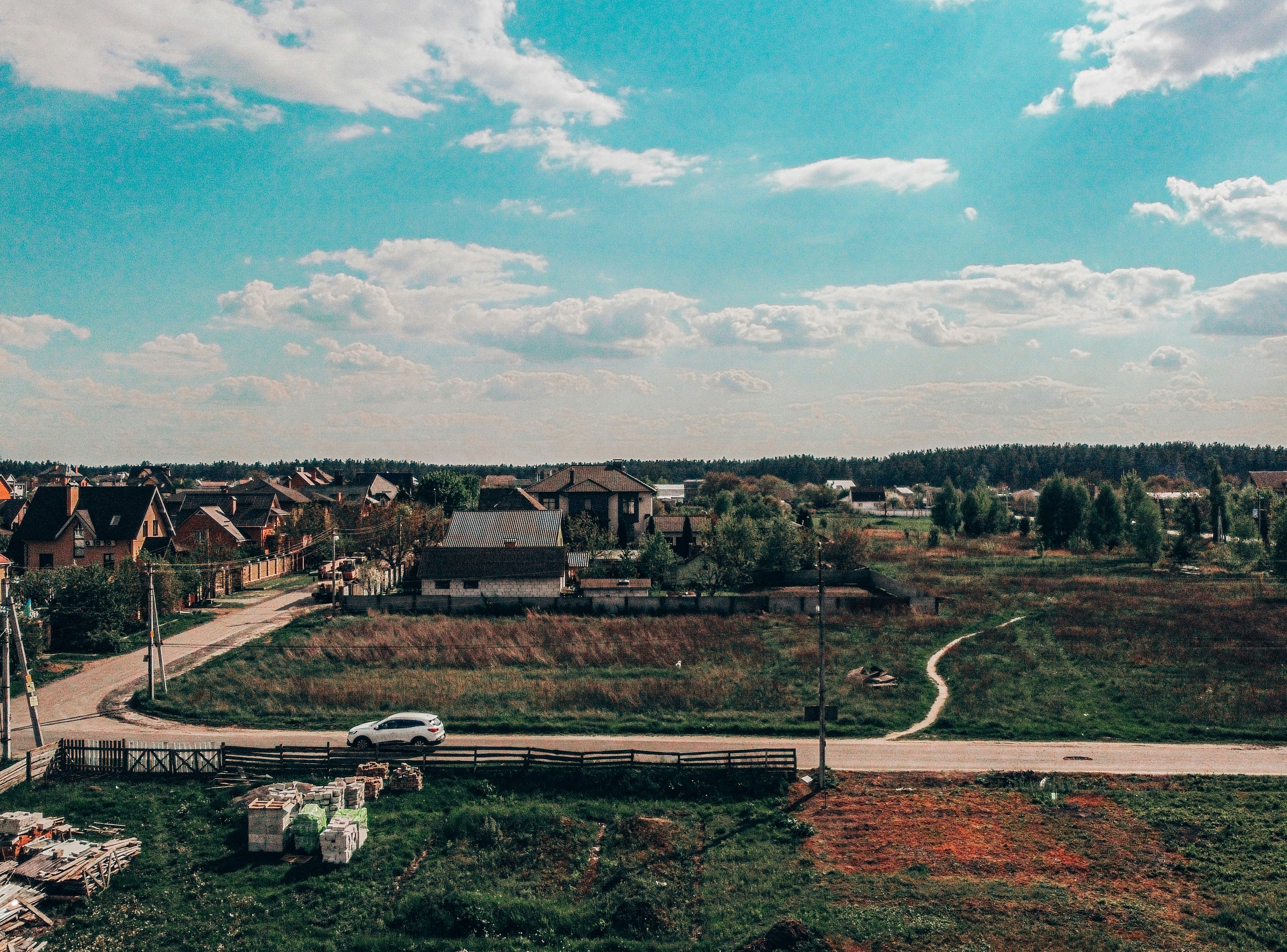 white and brown wooden picnic table on green grass field during daytime
