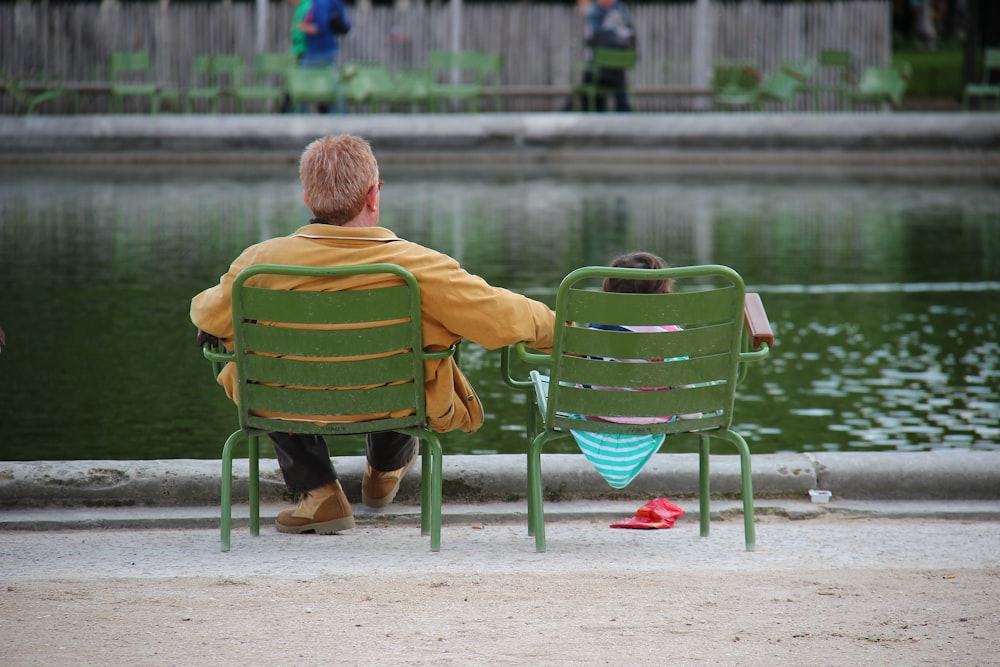 man in yellow shirt sitting on green chair