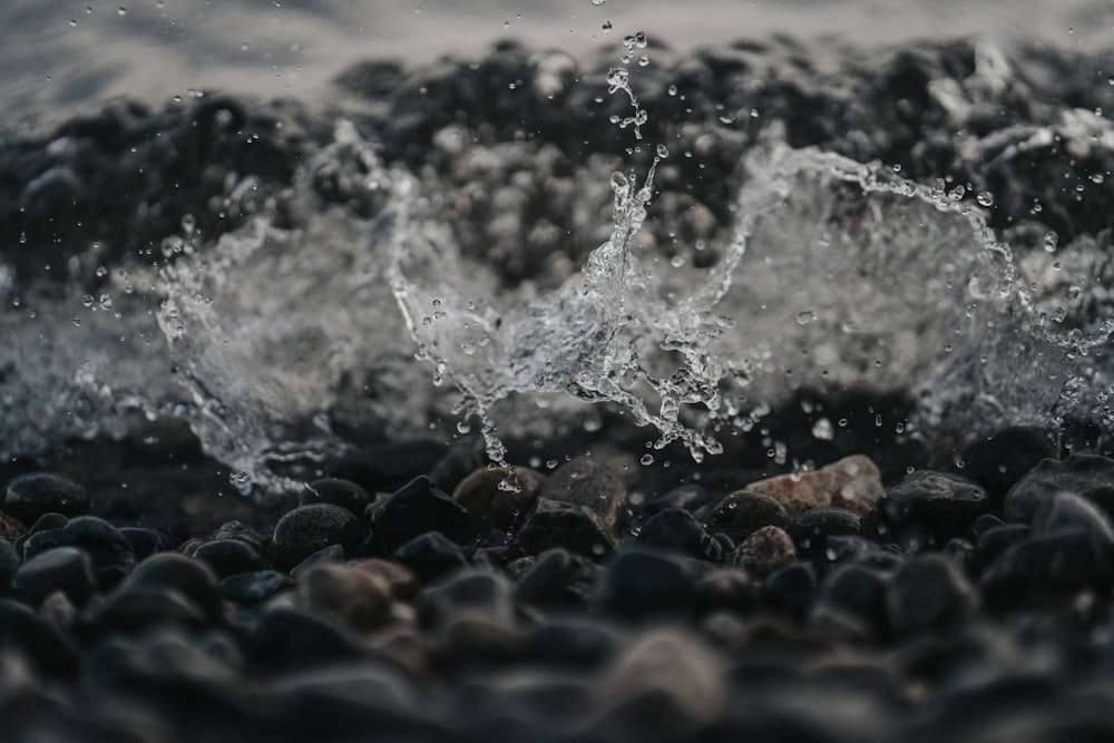 water splash on black rocks