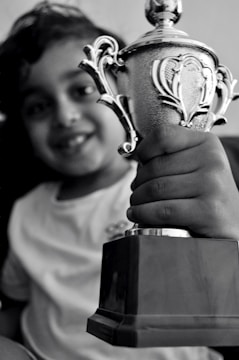 A smiling student receiving a scholarship award in a classroom.