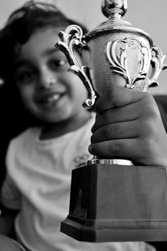 A happy customer holding a trophy at an award ceremony.