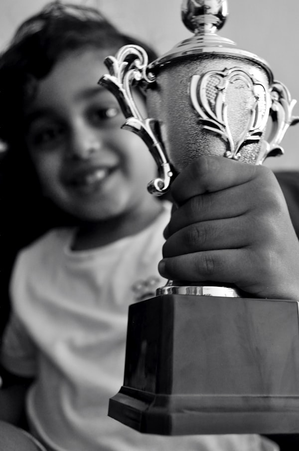 Student proudly holding a trophy