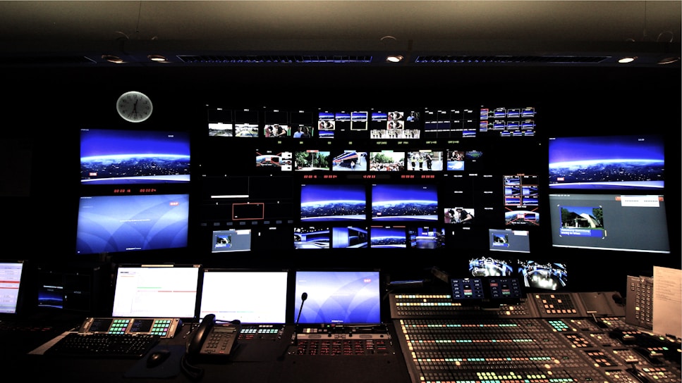 A modern security control room with multiple screens displaying surveillance footage.