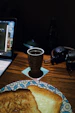 A warm, inviting workspace with a laptop, notebook, and a cup of tea by a window.