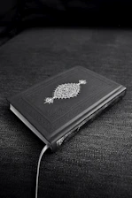 Mystical ancient book glowing with arcane symbols on a dark background