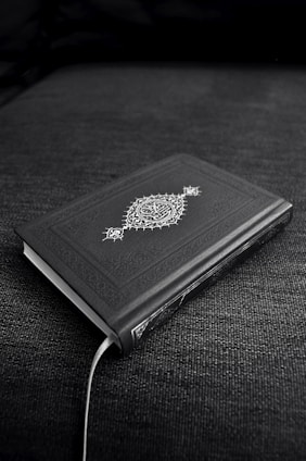 A mystical ancient book surrounded by symbols and glowing light.