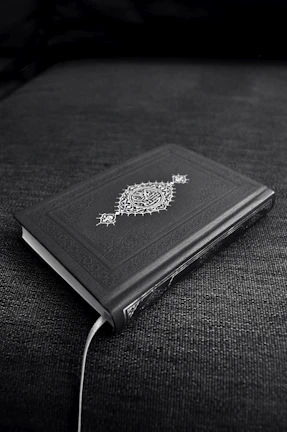 Notebook with a black cover displaying a detailed mystical eye symbol.
