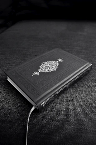 Mystical ancient book glowing with arcane symbols on a dark background