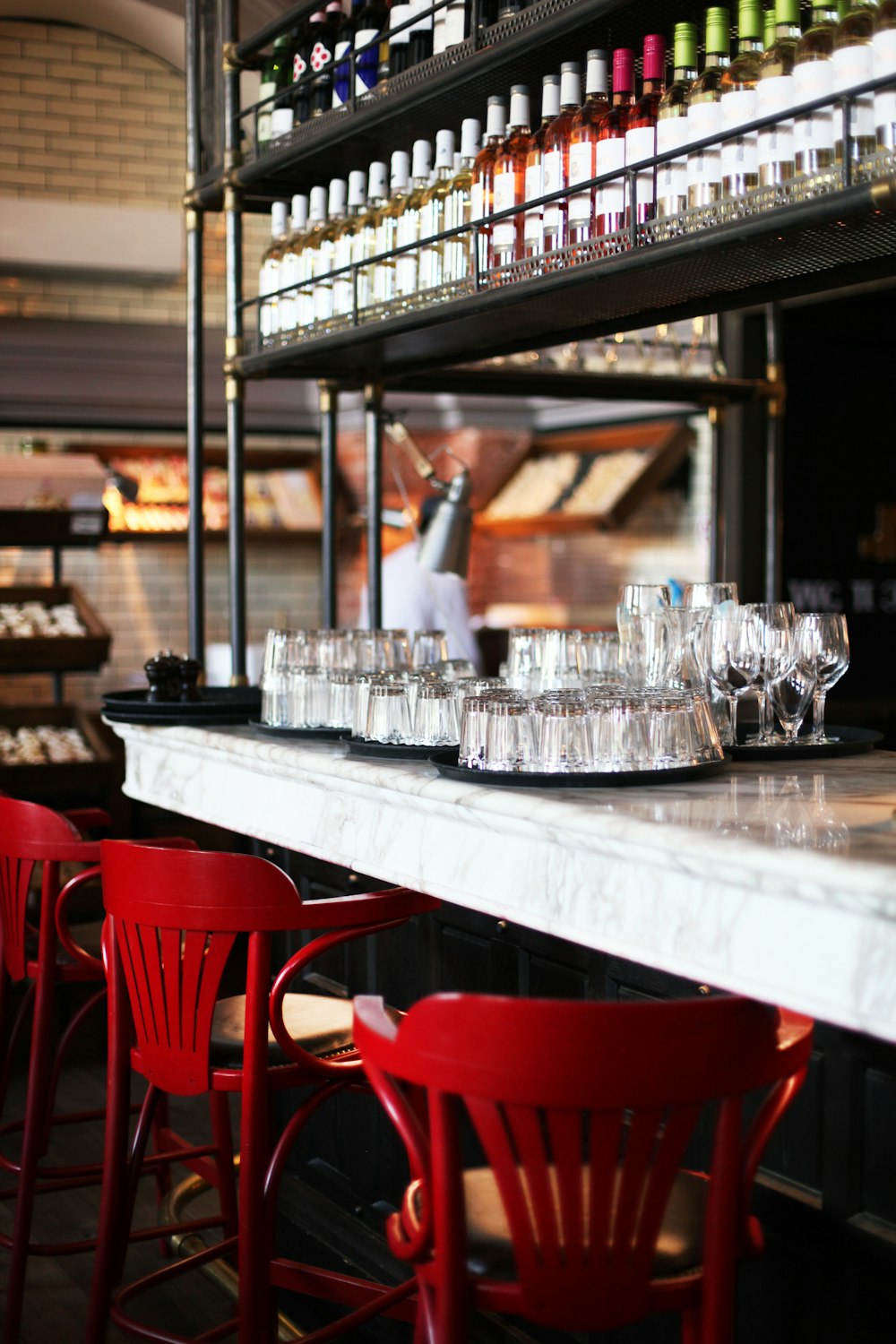 a row of red chairs sitting next to a counter