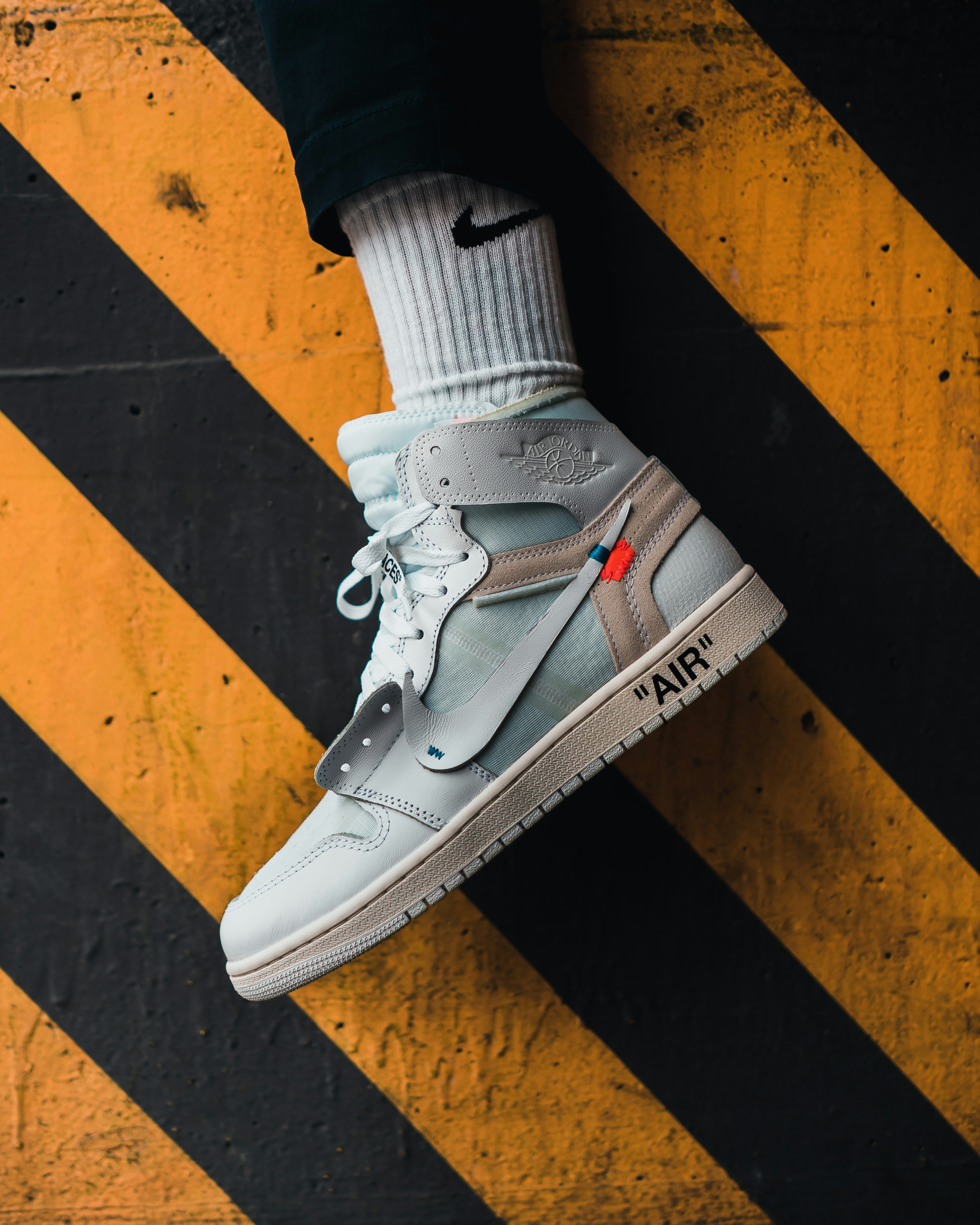 person wearing white nike air force 1 high