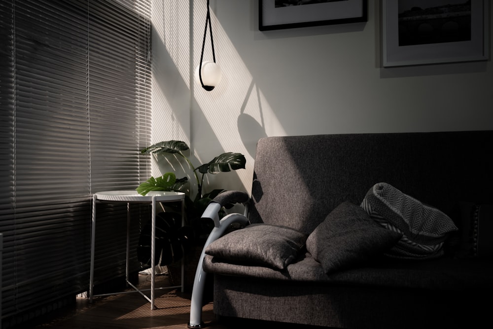 gray sofa chair beside window