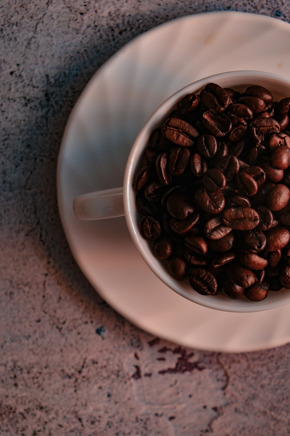 coffee beans on white ceramic mug