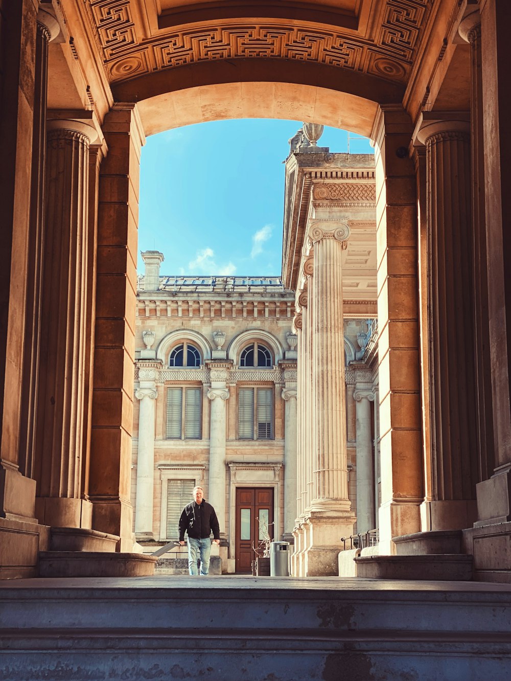 people walking in front of brown concrete building during daytime