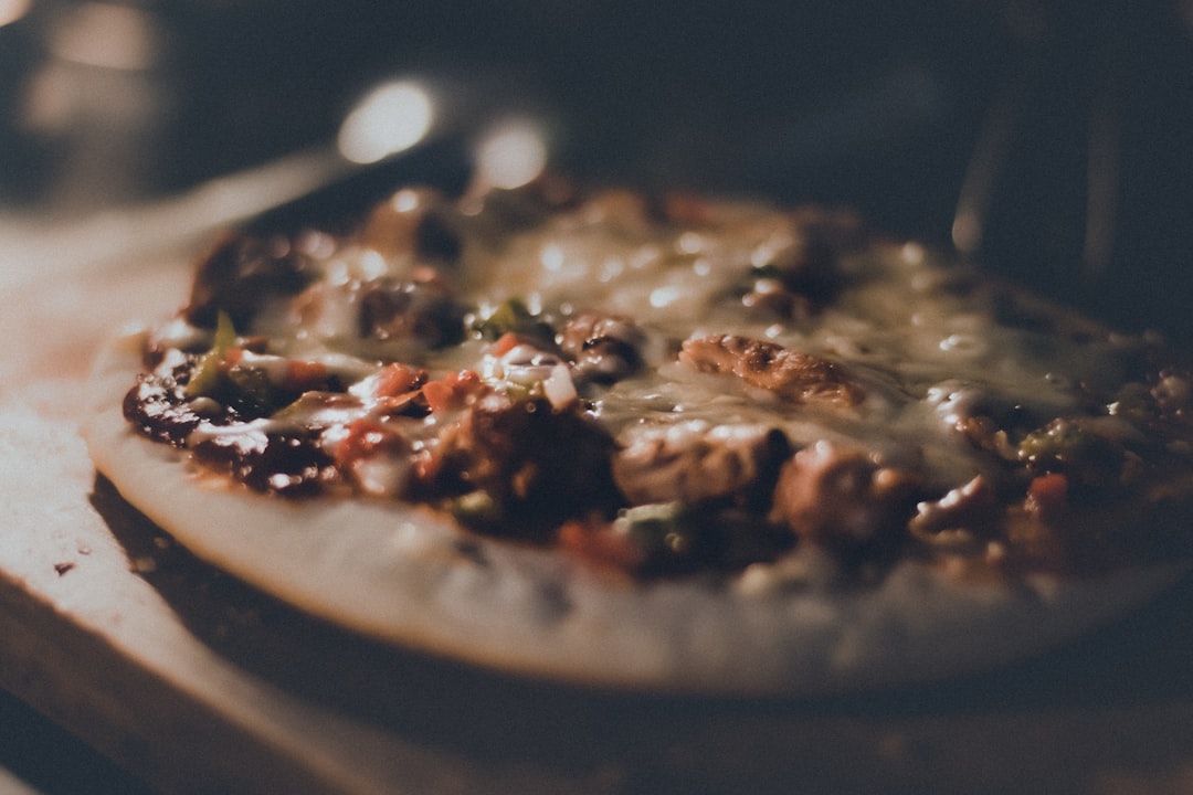 brown and black pizza on black plate