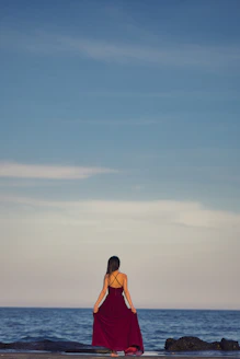 woman in orange bikini standing on beach during daytime