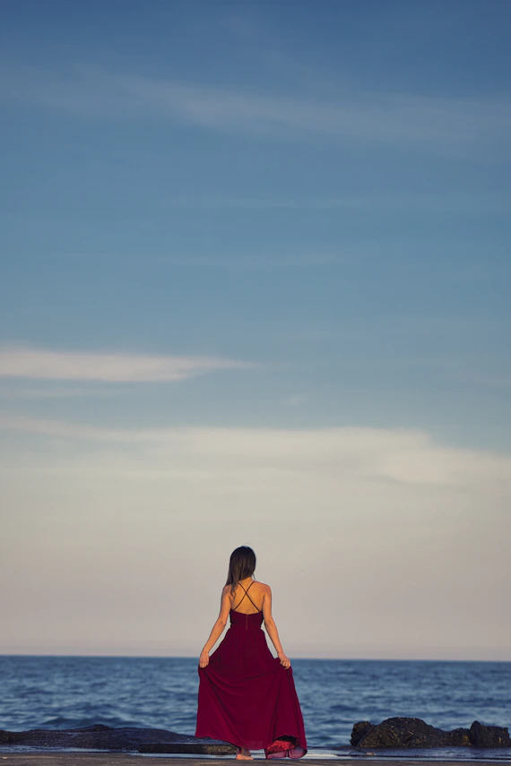 woman in orange bikini standing on beach during daytime