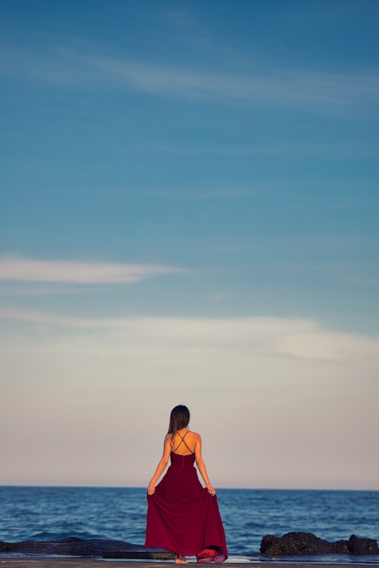 woman in orange bikini standing on beach during daytime in Burgas Bulgaria