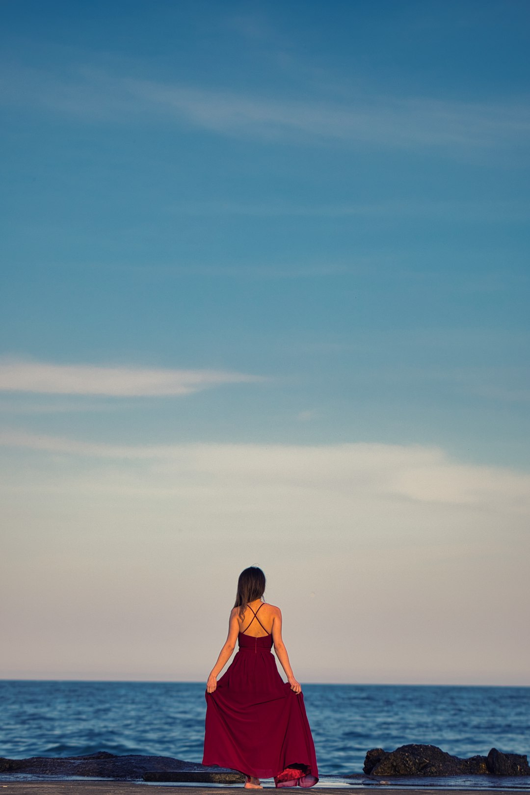 woman in orange bikini standing on beach during daytime