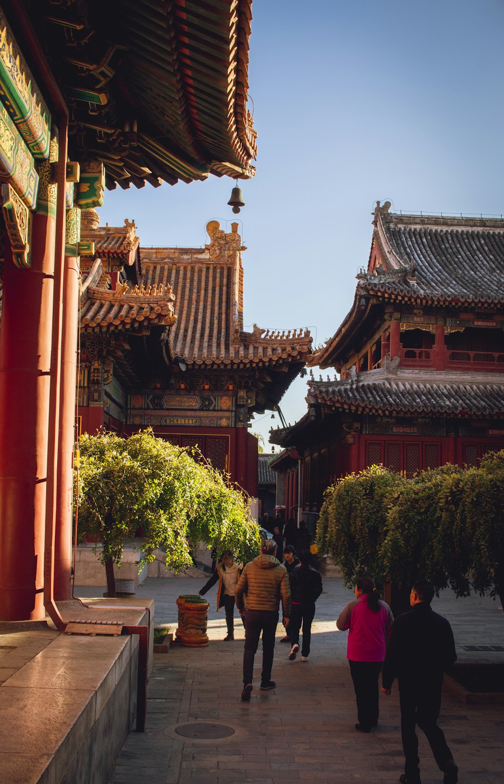 people walking on red and brown temple during daytime