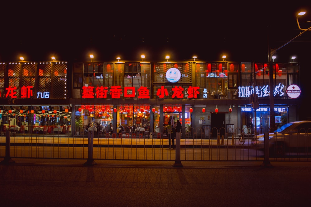 people walking on sidewalk during night time