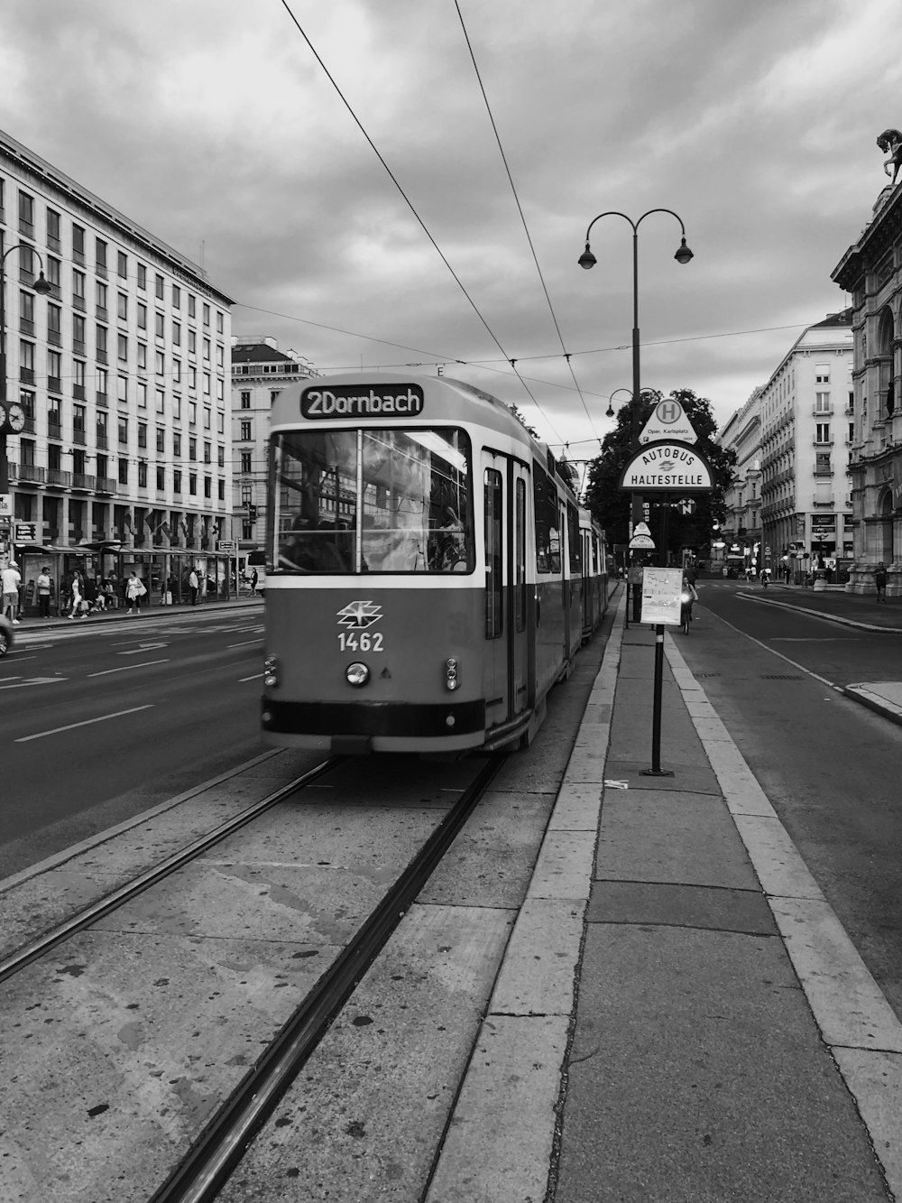 grayscale photo of tram on road