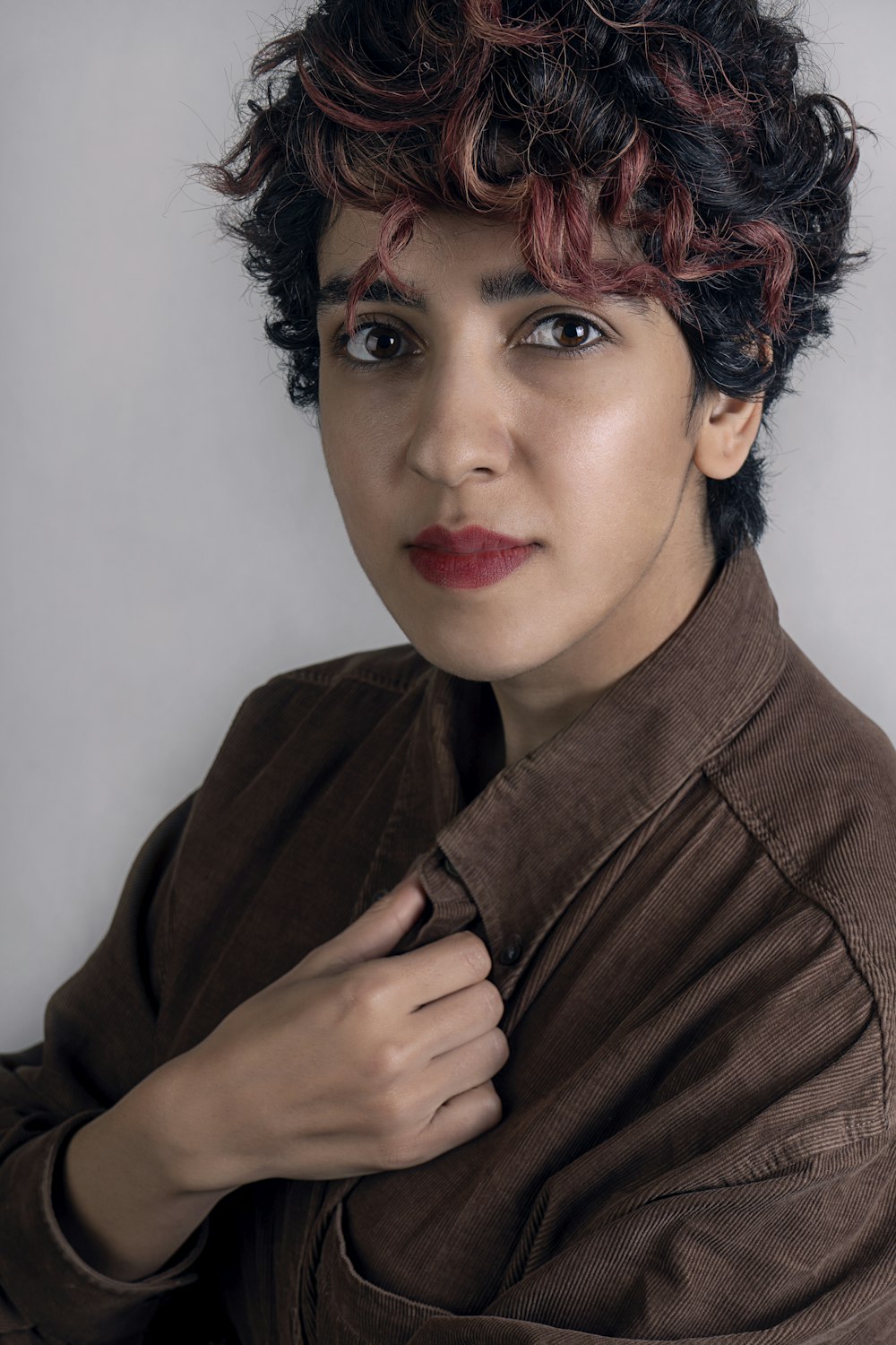 woman in brown coat with red lipstick