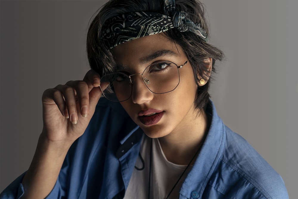 woman in blue blazer wearing black framed eyeglasses